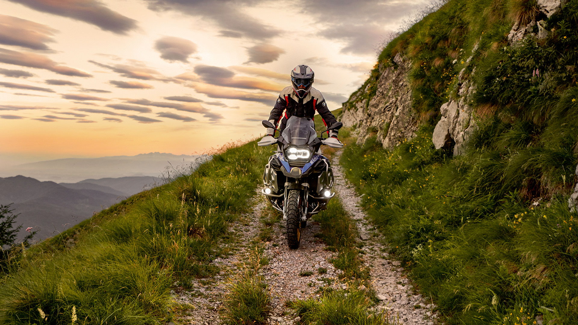 Riding scene with the BMW R 1250 GS Adventure in the mountains on unpaved road