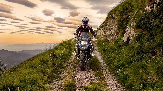 Riding scene with the BMW R 1250 GS Adventure in the mountains on unpaved road